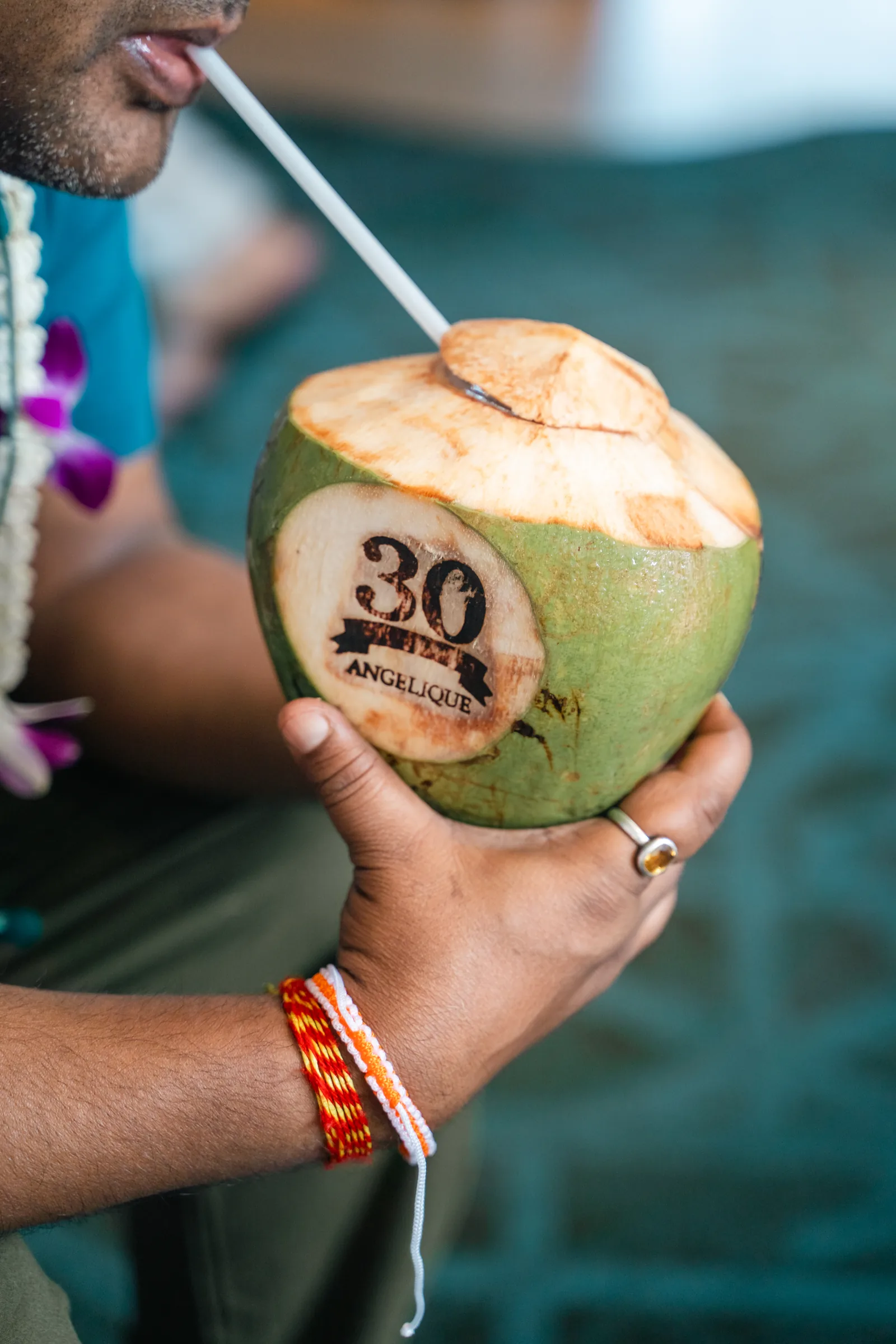 A branded fresh coconut prepared as an event welcome detail