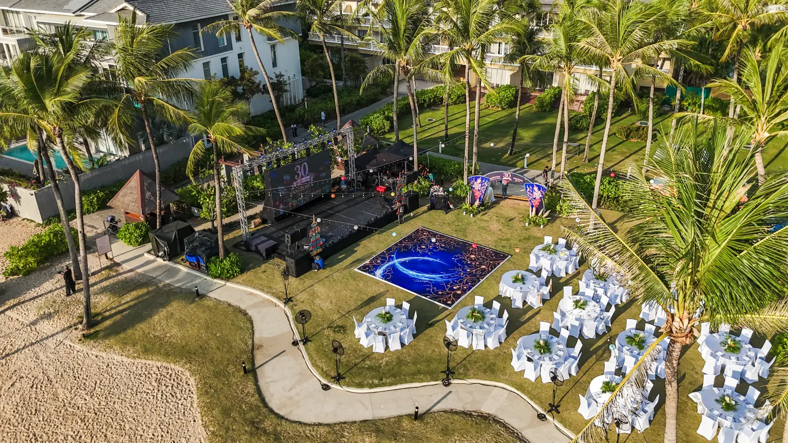 Aerial view of an outdoor corporate event setting beside the beach