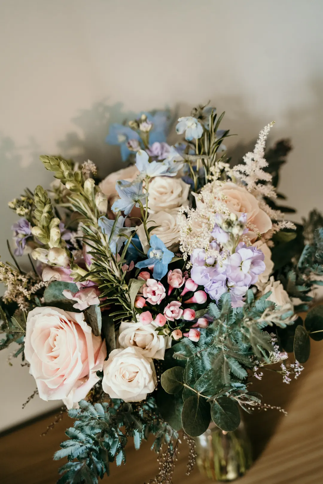 Wedding bouquet arranged beside bridal shoes